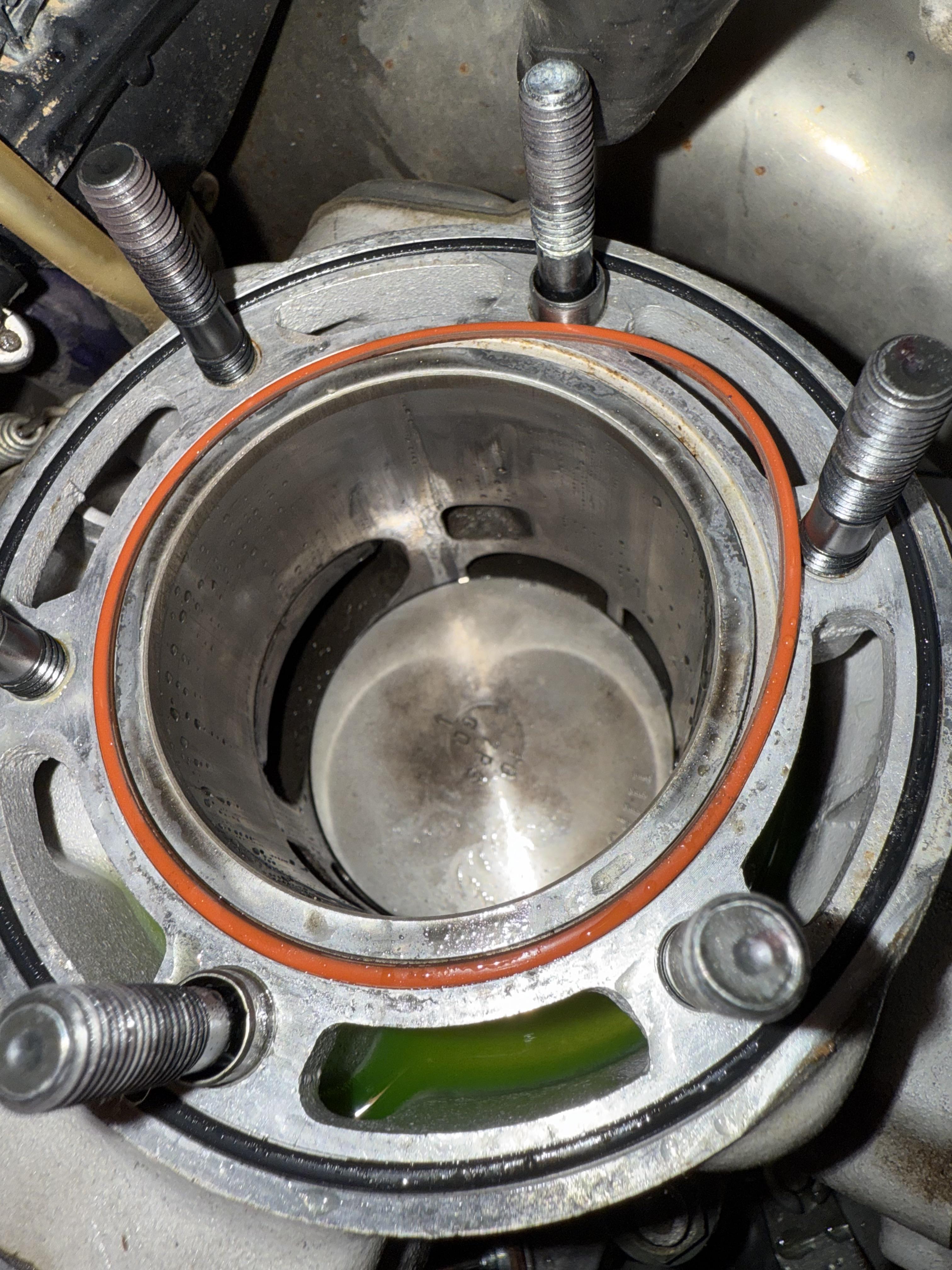 a 2 stroke dirt bike engine cylinder with a piston top showing